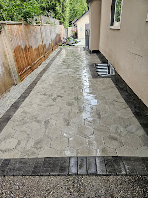Flagstone paver walkway with a dark border beside a Langley home